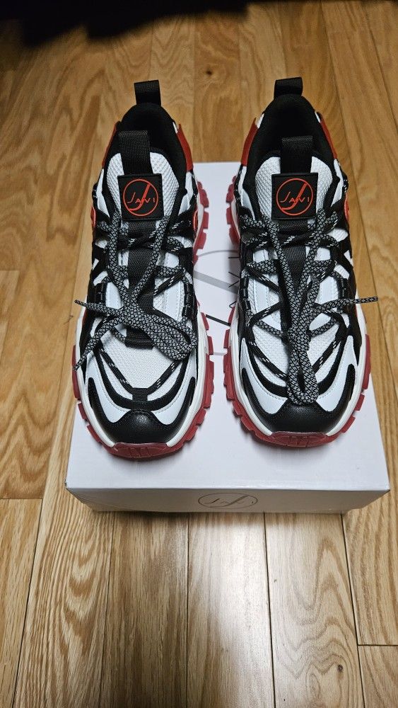 The Javi Swipe athletic shoe,red and white with black trim. Size 9.5.