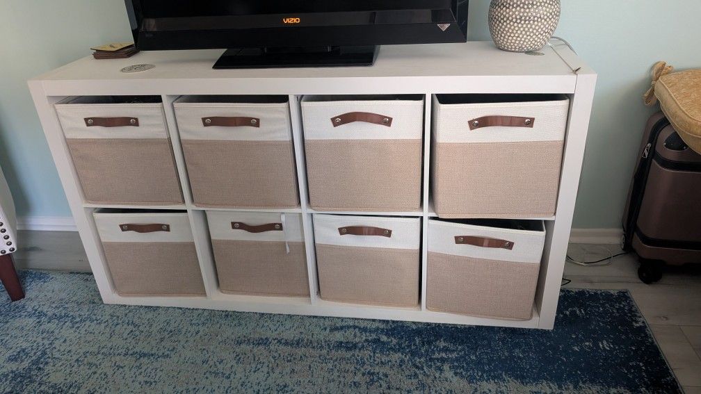 white  cube storage unit With  eight two-toned storage bins. 
