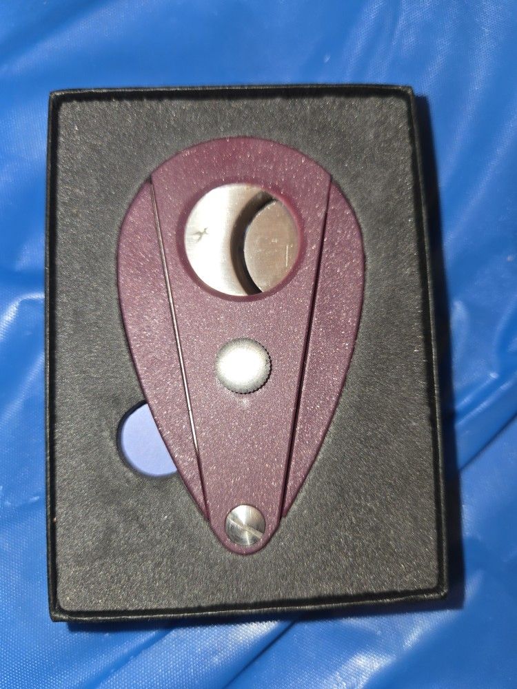 New Purple xikar cigar cutter in box with booklet.