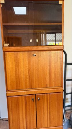 Wooden shelving unit with wood and glass drawers