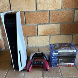 PlayStation 5 with controllers and games
