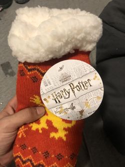 Harry Potter one size fits ok gryffondor house with the logo at the bottom . With the lion in the middle never worn selling for less than half retail