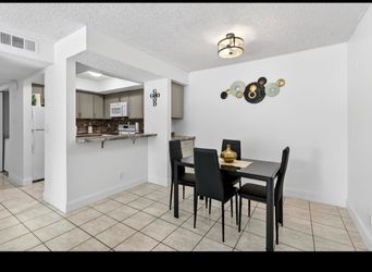 Small and cozy dining room table with four chairs