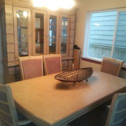 Dining room set. Large table with 6 chairs two of which are captain chairs. Large touch light hutch. Marble top buffet.