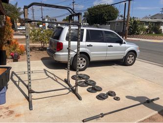Squat rack, Olympic bar, and weights!