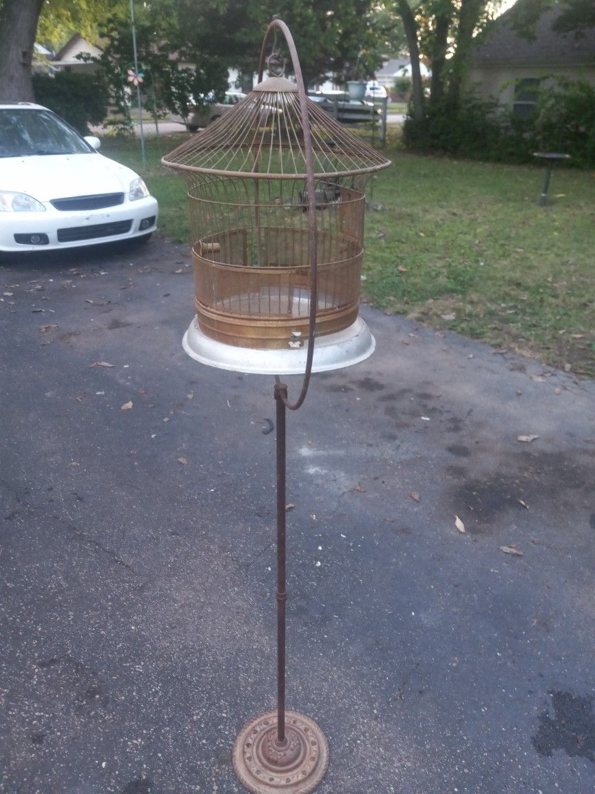 Antique freestanding bird cage with large hoop ring base on cast iron stand,