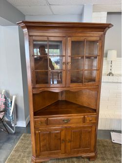 solid maple Temple Stuart corner cabinet featuring a lighted upper display section and lower storage drawers.