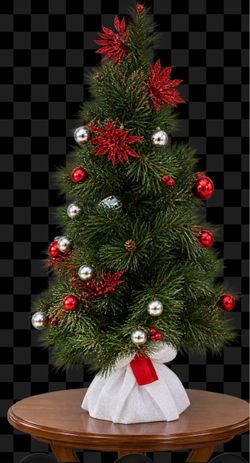 Christmas tree table top with ornaments and white fabric base