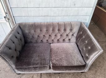 Gray upholstery two seater couch
