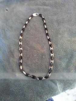 Man's black and silver colored necklace