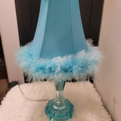 One-light table lamp in blue resin with a fabric shade and feather trim 18.5" H