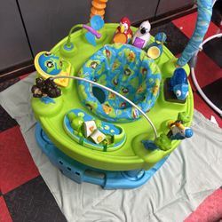 Colorful baby activity center with toys and seat. Adjustable height 