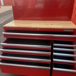 Husky 52 in. W 10-Drawer Gloss Red Mobile Workbench Cabinet with Solid Wood Top and Pegboard Small Dent You Can See In The Picture 👁️