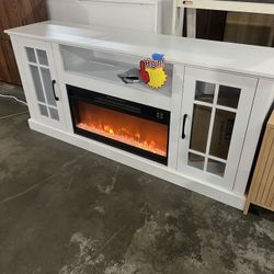 Tv stand with fireplace. Blows heat and can change colors in the fireplace. 63.5" w x 18" d x 33" h.  Brand new  $200   Warehouse Clearance Sale   🔥F