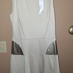 Singles beige sleeveless top or dress featuring a distinctive gold foil or metallic faux leather detail on it size  Medium $45
