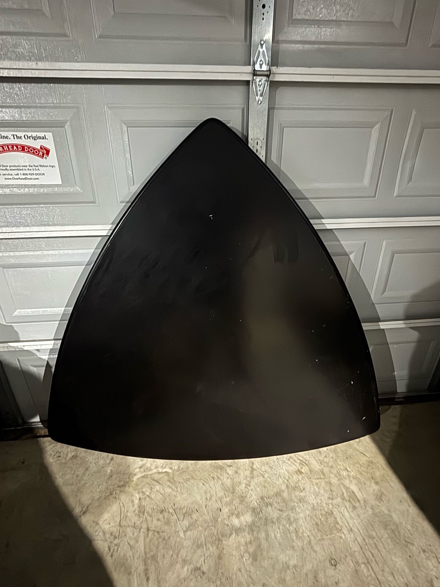 Black triangle table with two benches.