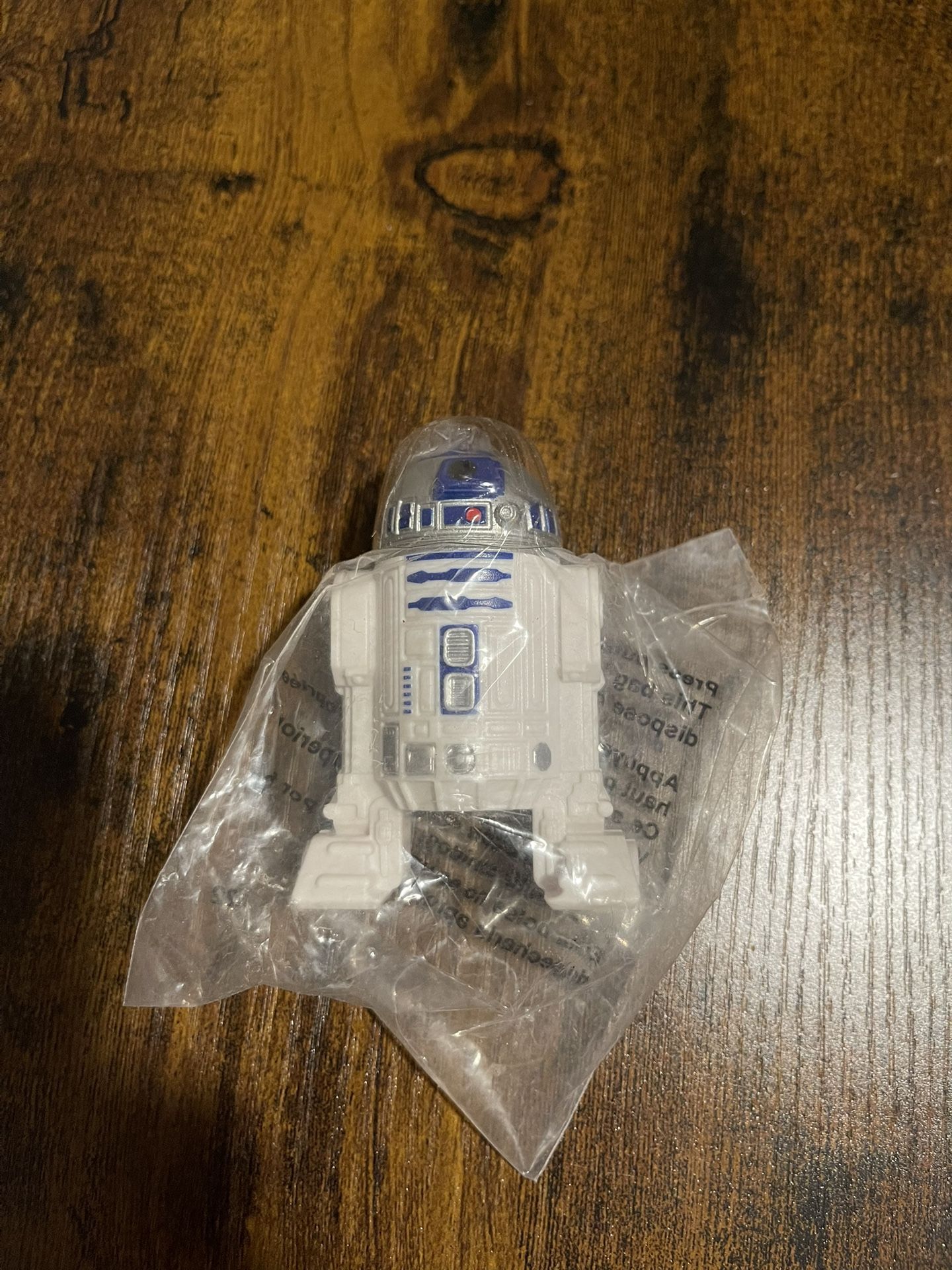 R2-D2 action figure, likely from the Star Wars franchise