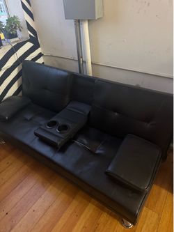 Black leather retractable couch turned bed