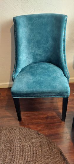Two dark teal rustic gold studded chairs