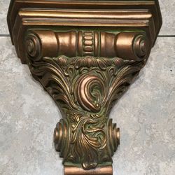 Elegant gold leafed wall shelf with groove for a plate