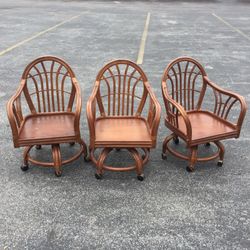 Set of three rattan swivel chairs