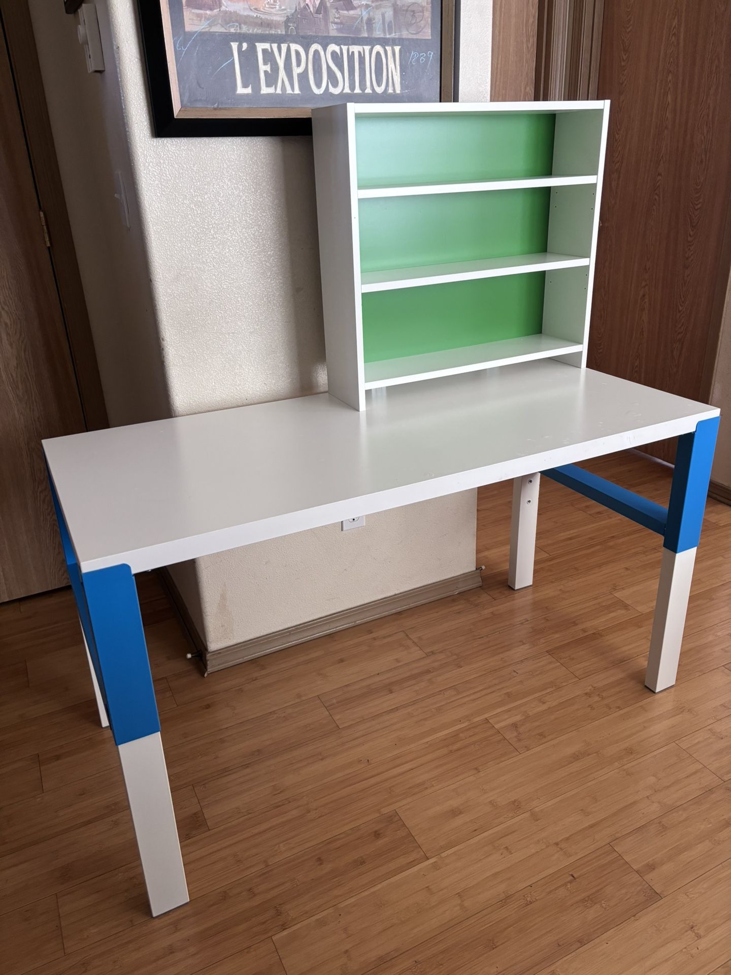 Multicolored desk with filing cabinets.