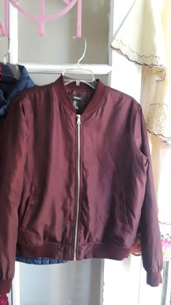 Jacket burgundy new. Size Medium, pockets on each side. It says love Yourself letters are embroidered
