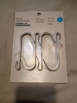 A package of silver utility hooks. Labeled as Strata Utility Hooks Room Essentials.