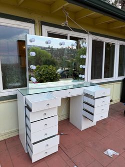 white vanity with light bulbs