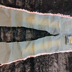 IamGia blue jeans with pink ribbon ties laced down side cutouts on both legs . Super cute . . Size 5