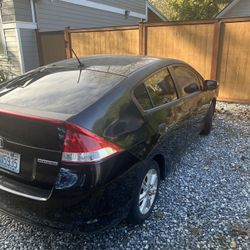 2010 Honda Insight hybrid, great on gas. Exterior is black, Interior is light gray. Runs and drives ! Currently has 169199 miles.   
