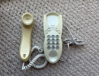 Corded landline telephone with memory redial program mute function