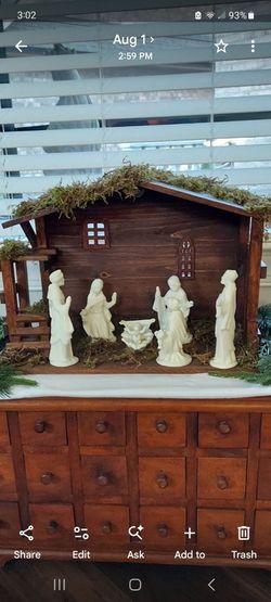White bisque nativity with wooden cresch