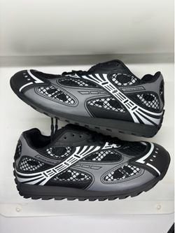 Authentic Bottega Veneta Orbit sneakers in a black and silver colorway. These shoes have a technical mesh upper with synthetic overlays and a rubber o