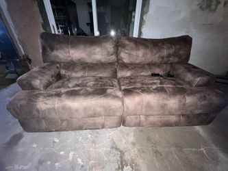 Brown plush reclining sofa with chargers