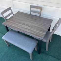 LIKE NEW 5-PC MINIMALIST LIGHT WEIGHT GRAY FINISH DINING SET (1 TABLE 3 PADDED CHAIRS AND ONE PADDED