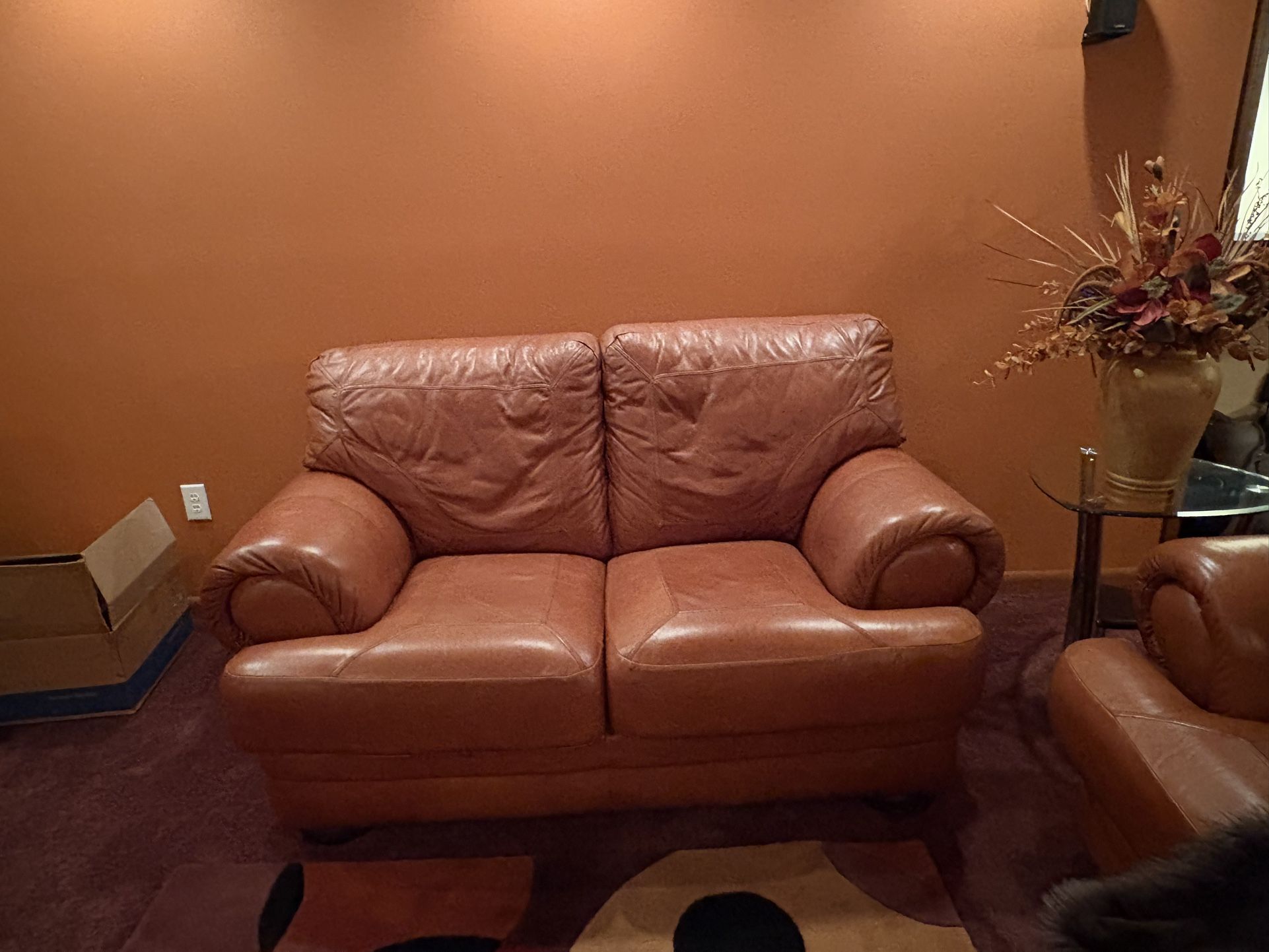 Terra-cotta genuine, leather sofa, and loveseat