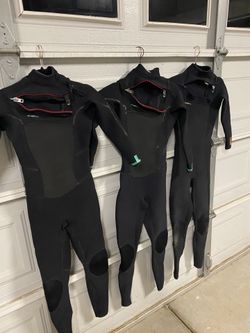 Women’s wetsuits and surfboard