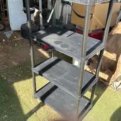 Plastic shelving unit 54 inches high by 28 inches long and 15 inches wide