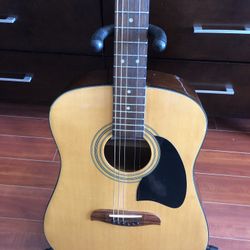 Acoustic guitar with stand
