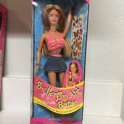 1998 Butterfly Art Barbie doll, Mattel. Includes two sheets of temporary tattoos for both the doll and the owner.  The doll wears a pink and yellow kn