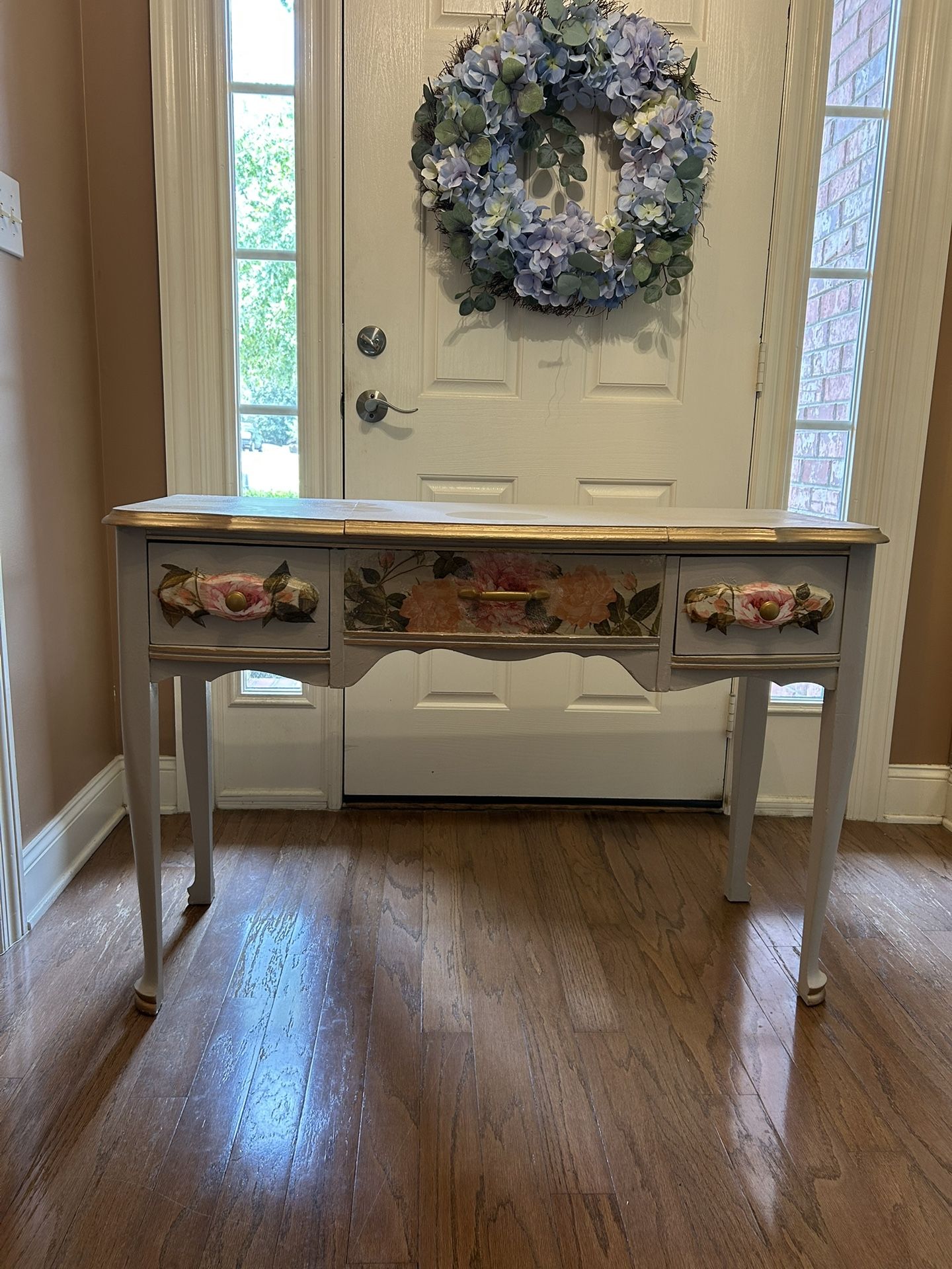 FRENCH PROVINCIAL VANITY WITH ARTISTIC FLORAL DECOR AND ANTIQUE GOLD ACCENTS.