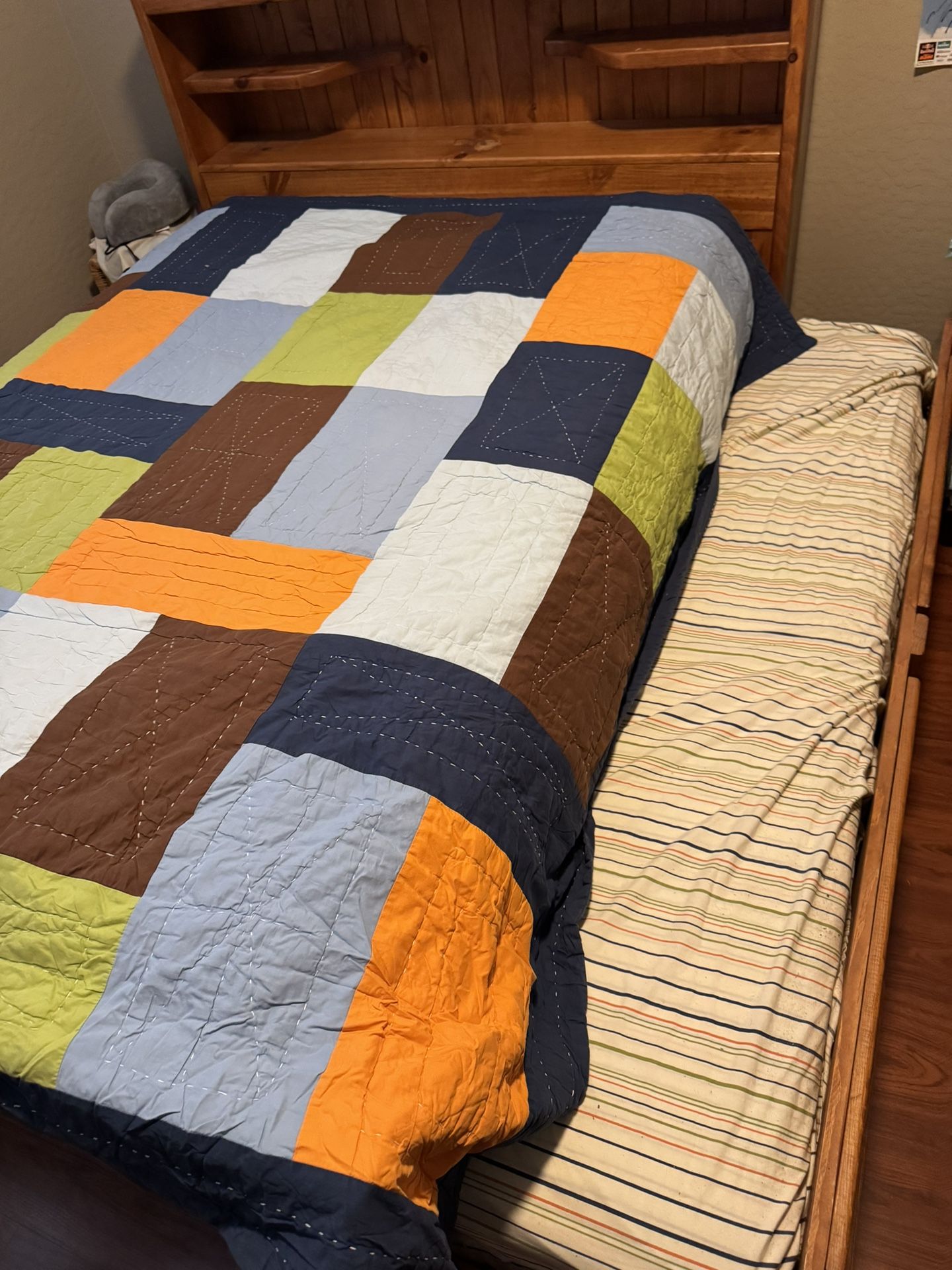 Full bed with wooden bed frame and trundle