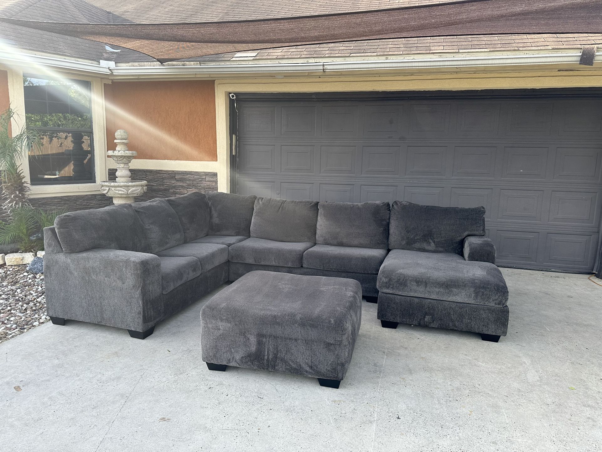 Beautiful dark grey sectional with ottoman in great condition very comfortable and clean asking 680