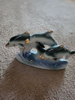 3 Dolphins Riding A Wave