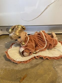 Porcelain Doll On Blanket
