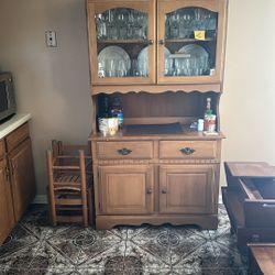 This is a wooden hutch or china cabinet. 