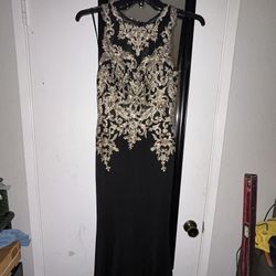 Sleek black floor‑length gown with fitted sleeveless cut