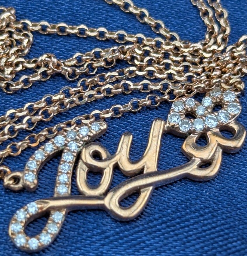 14K Rose Gold JOY Script Pendant suspended from a dainty 14K Rose Gold Necklace With 33 meleé diamonds