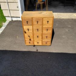  Twelve drawer pine cabinet with handforged iron pulls 